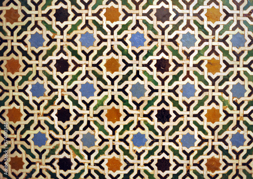 Arab geometric mosaic of the Alhambra in Granada, Spain. Al Andalus tiles called alicatados. Arabic tiles of eight pointed stars. Alhambra Palace in Granada, a UNESCO World Heritage Site