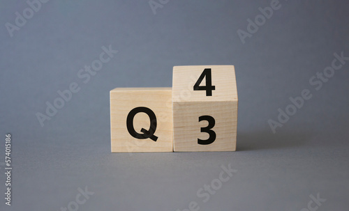 From 3rd Quarter to 4th symbol. Turned wooden cubes with words 3rd Quarter and 4th Quarter. Beautiful grey background. Business and Quarter concept. Copy space