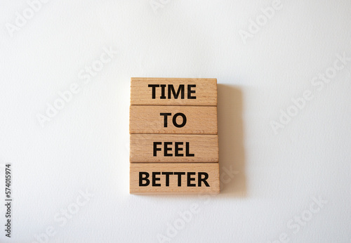 Time to feel better symbol. Wooden blocks with words Time to feel better. Beautiful white background. Medicine and Time to feel better concept. Copy space. photo