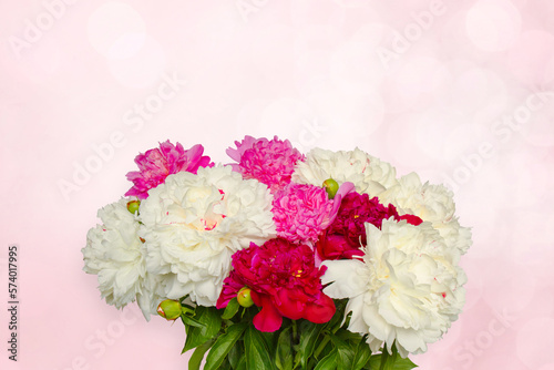 Bouquet of peony flowers on delicate pink background