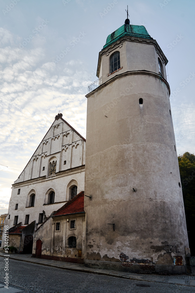 Brick tower of a historical church in the city of Wschowa in the evening