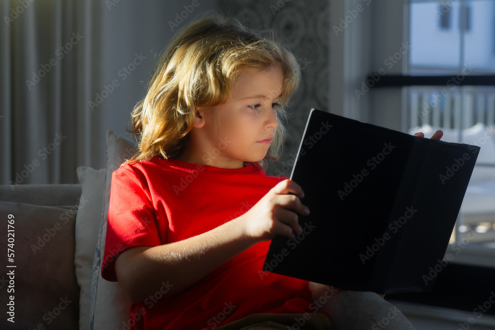 Obraz premium Smart, clever child. Intelligent kid boy read book. Kid read book at home.