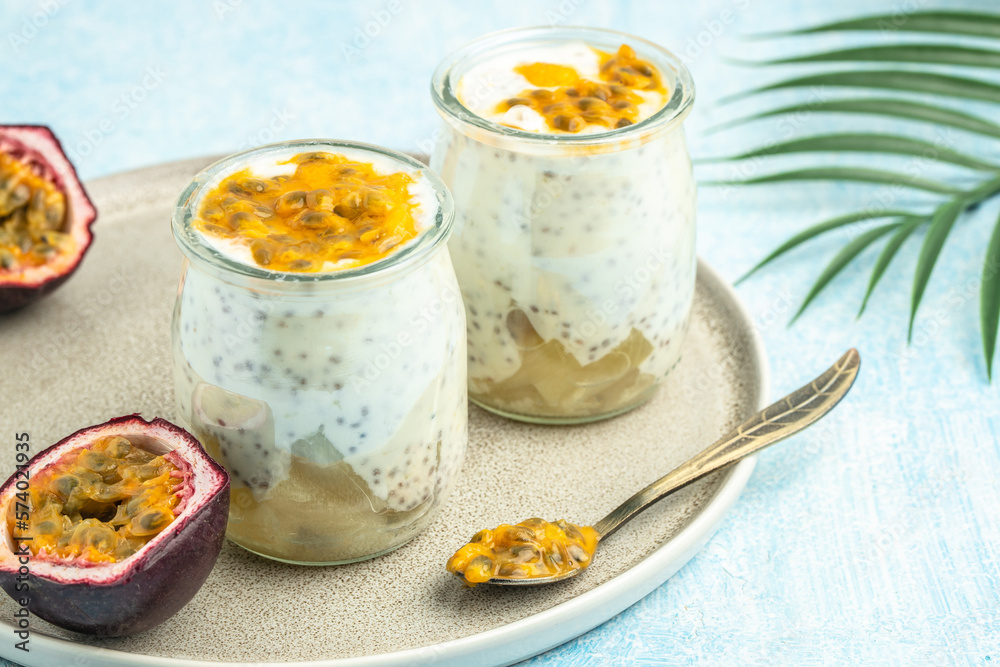 Healthy tropical fruit chia pudding with passionfruit in a glass, Delicious breakfast or snack, Clean eating, dieting, vegan food concept. top view Healthy tropical fruit chia pudding with passionfruit in a glass, Delicious breakfast or snack, Clean eating, dieting, vegan food concept. top view
