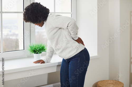Canvas Print Woman is suffering from strong back pain
