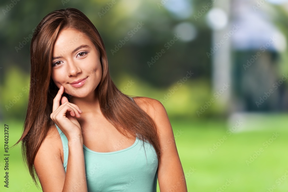 Happy young smart woman posing on outdoor background Happy young smart woman posing on outdoor background