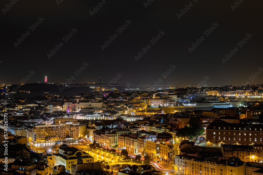 Beautiful panoramic aerial view of Lisbon at night, Christ the King, long exposure, Portugal