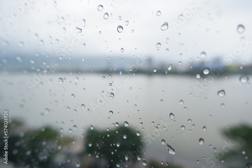 Rain falls on the window glass