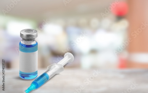 Vaccine medical bottle on desk in blur hospital