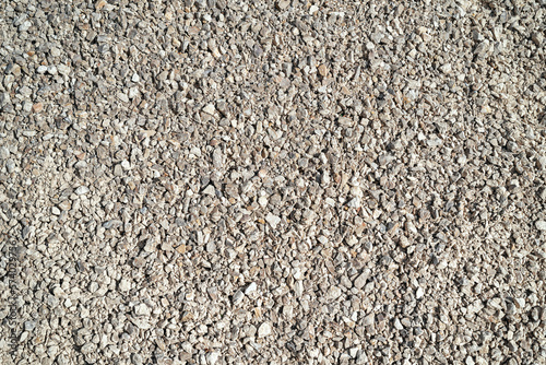 Top view grey and beige gravel stone background.