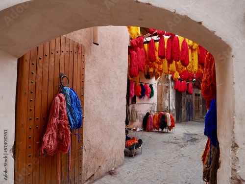 Bundles of orange and red wool hanging to dry at dyers souk, Marrakech, Morocco. photo