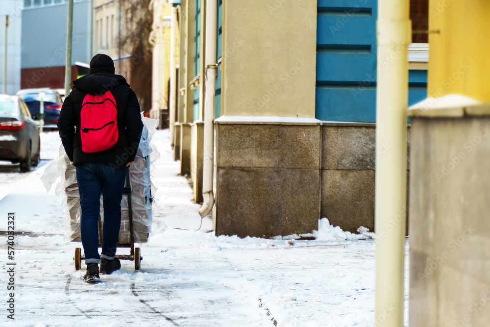 custom made wallpaper toronto digitalA worker in the morning carries a trolley with newspapers through the snow