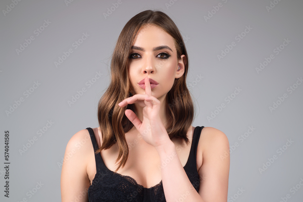 Girl showing shhh sign with finger near lips, standing over studio background. Women emotions. Secret young woman saying hush be quiet, shhh gesture. Quiet and silence. Human face expressions. Girl showing shhh sign with finger near lips, standing over studio background. Women emotions. Secret young woman saying hush be quiet, shhh gesture. Quiet and silence. Human face expressions.
