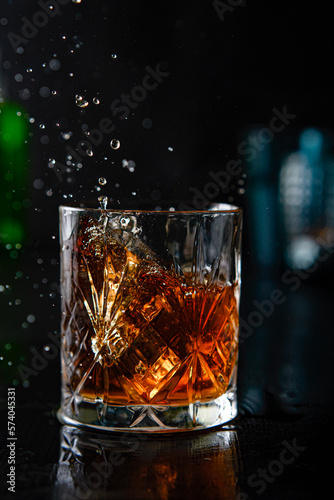 Splash in a glass of whiskey in a fancy bar
