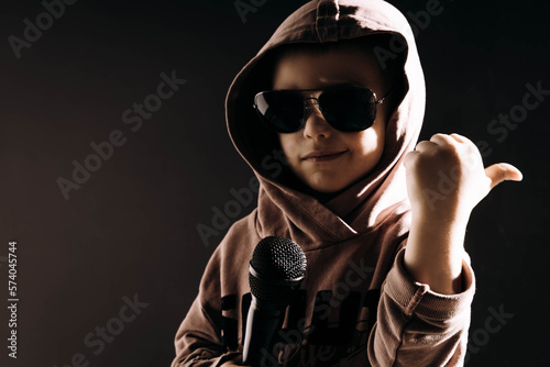 Chłopiec z mikrofonem śpiewa i jest ok, studio nagrań i młody wokalista