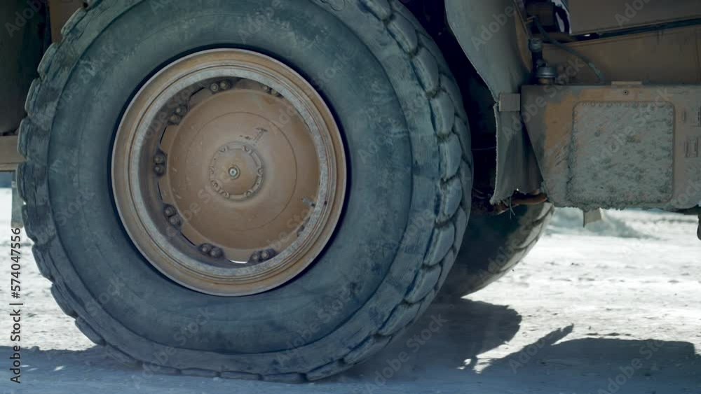 Driving dumper truck transporting ore digged at gold mine pit excavation quarry, slow motion Driving dumper truck transporting ore digged at gold mine pit excavation quarry, slow motion