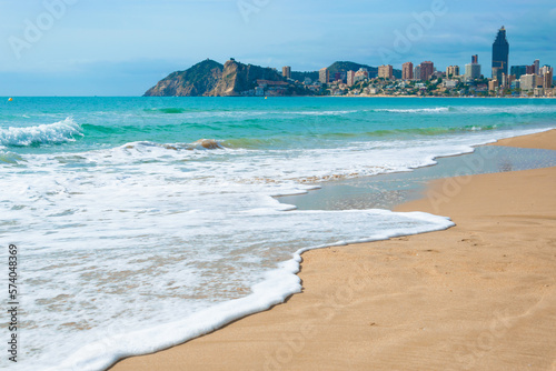 Cityscape of Benidorm city, Costa Blanca, Spain. View from the Levante beach to the Benidorm city and Poniente beach. Sea, golden sand and skyscrapers. photo