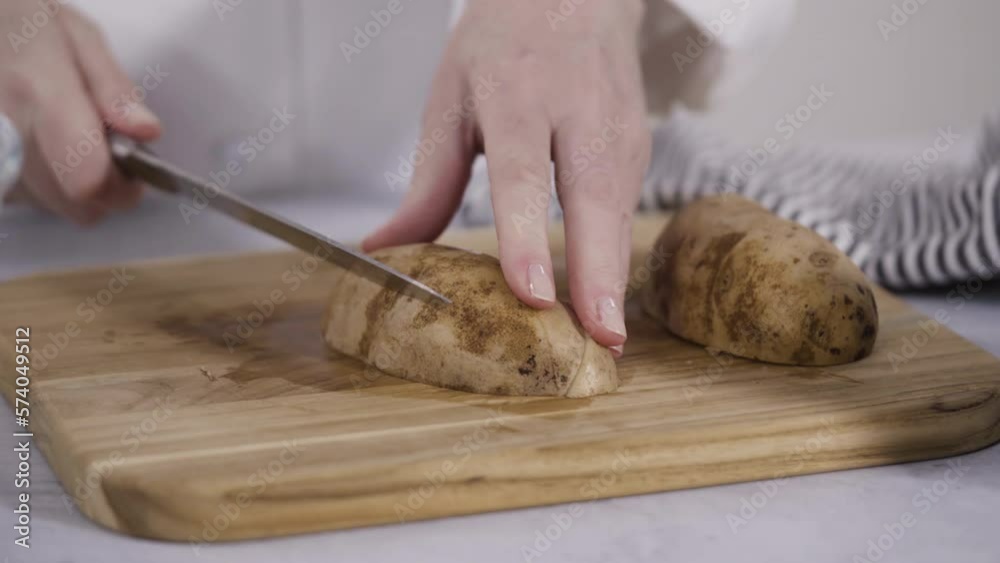 Time lapse. Step by step. Slicing russet potatoes in wedges with olive oil and spices to bake in the oven. Time lapse. Step by step. Slicing russet potatoes in wedges with olive oil and spices to bake in the oven.