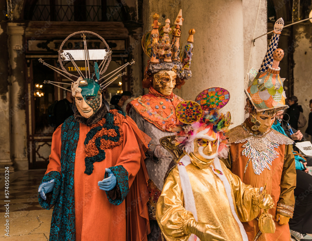 People wearing colorful and elaborate masks and costumes during the Venice carnival in Italy