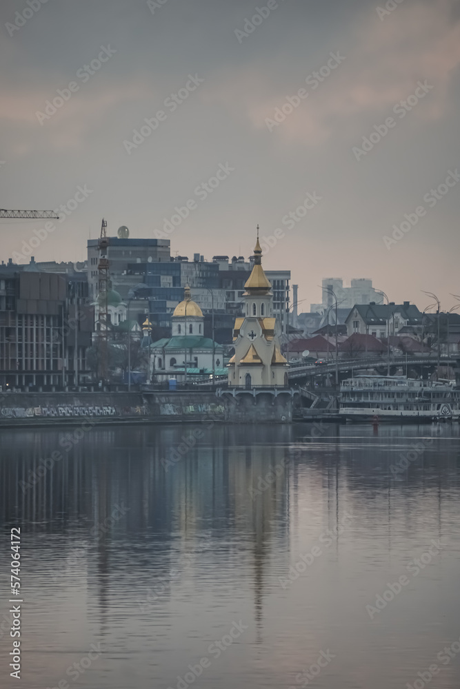 Fototapeta premium Panoramic view of the city of Kyiv and the Dnieper river in the evening, view of the old city and high-rise buildings in the background