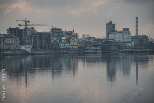 Panoramic view of the city of Kyiv and the Dnieper river in the evening, view of the old city and high-rise buildings in the background