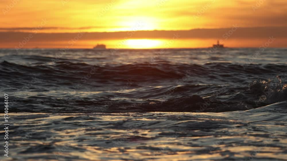 Dark sea waves under an orange bright sunset Dark sea waves under an orange bright sunset