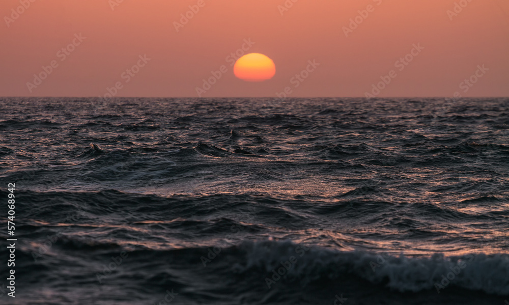 Orange sunset over the sea water surface