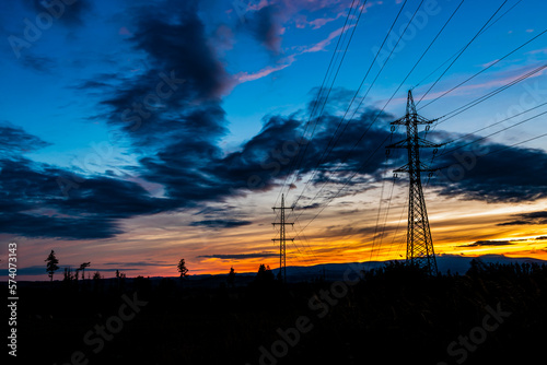 Sunset with high voltage pylons and power lines
