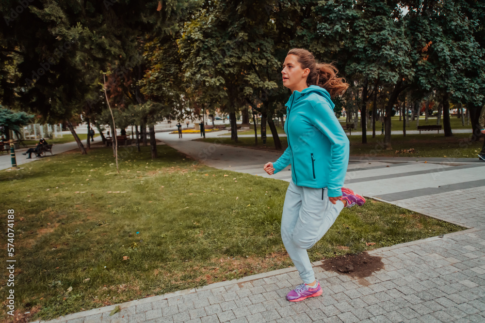 Fototapeta premium Women in sports clothes running in a modern urban environment. The concept of a sporty and healthy lifestyle