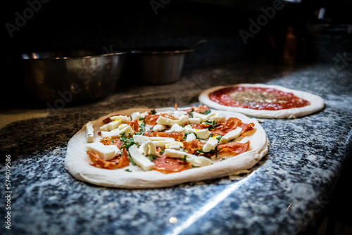 Pizza napoletana in preparation by pizzaiolo
