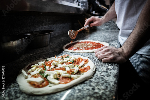 Pizza napoletana in preparation by pizzaiolo