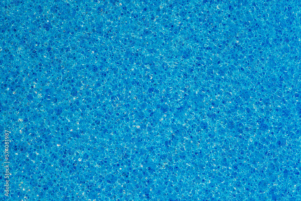 Foam rubber blue sponge, polygonal pores close-up background wallpaper, uniform texture pattern