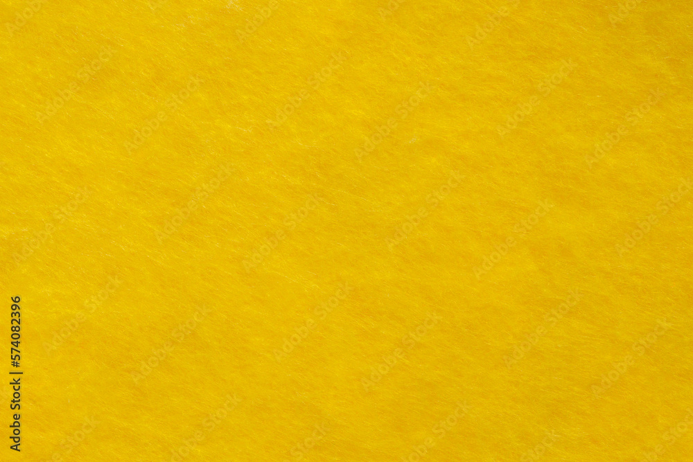 Fabric is fleece non-woven yellow, background wallpaper, uniform texture pattern Fabric is fleece non-woven yellow, background wallpaper, uniform texture pattern