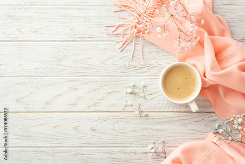Hello spring concept. Top view photo of cup of cocoa gypsophila flowers and pink plaid on grey wooden desk background with copyspace