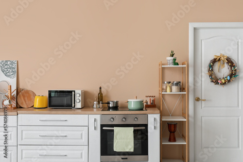 Interior of stylish kitchen with Easter decor and white counters