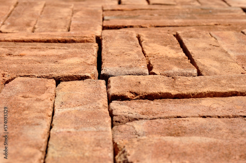 Pile of red bricks texture background selective focus