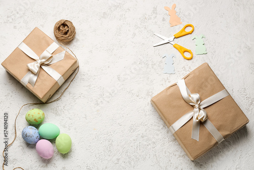 Frame made of gifts, Easter eggs, scissors and rope on grunge background © Pixel-Shot