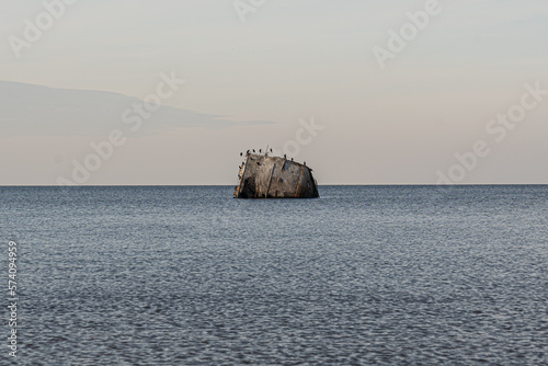 Concrete ship wreck by the coast in the Baltic Sea photo