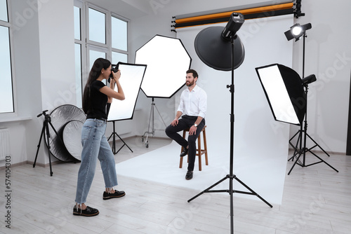 Handsome model posing for professional photographer in studio photo