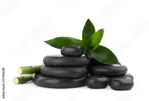 Stacks of spa stones and bamboo on white background