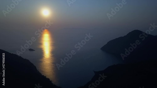 Rich gold and blue ocean sunset, seen from mountain island aerial photo