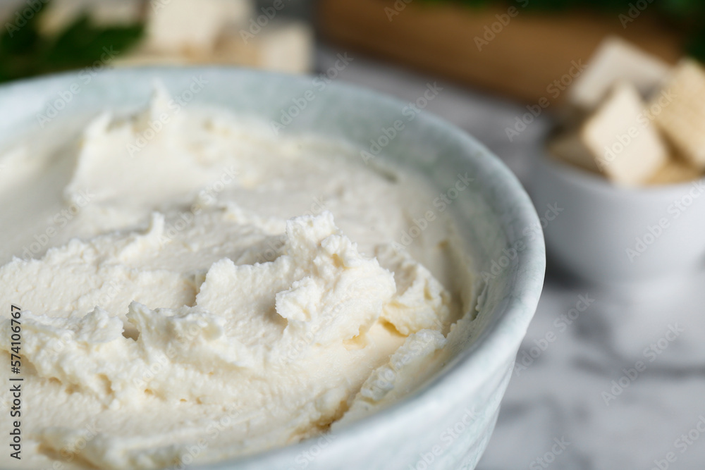 Delicious tofu cream cheese in bowl on table, closeup view Delicious tofu cream cheese in bowl on table, closeup view