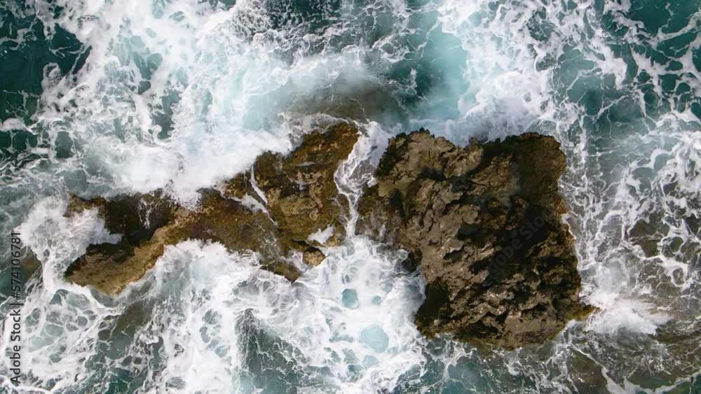 Aerial, top-down, close-up view of sea water washing rocks in 240fps slow motion Aerial, top-down, close-up view of sea water washing rocks in 240fps slow motion