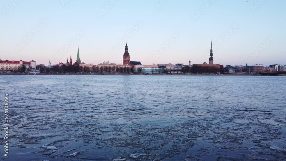 Icy Daugava river and towers of Riga skyline, low altitude aerial view Icy Daugava river and towers of Riga skyline, low altitude aerial view