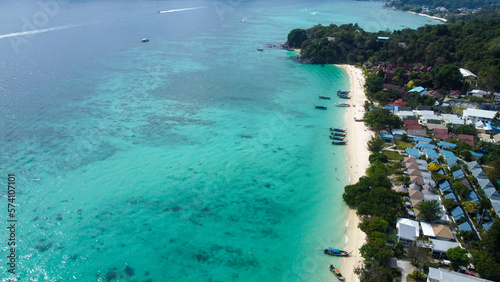 Aerial view of beautiful white sand beach and turquoise waters of Andaman Sea, Phi Phi, Krabi, Thailand. 