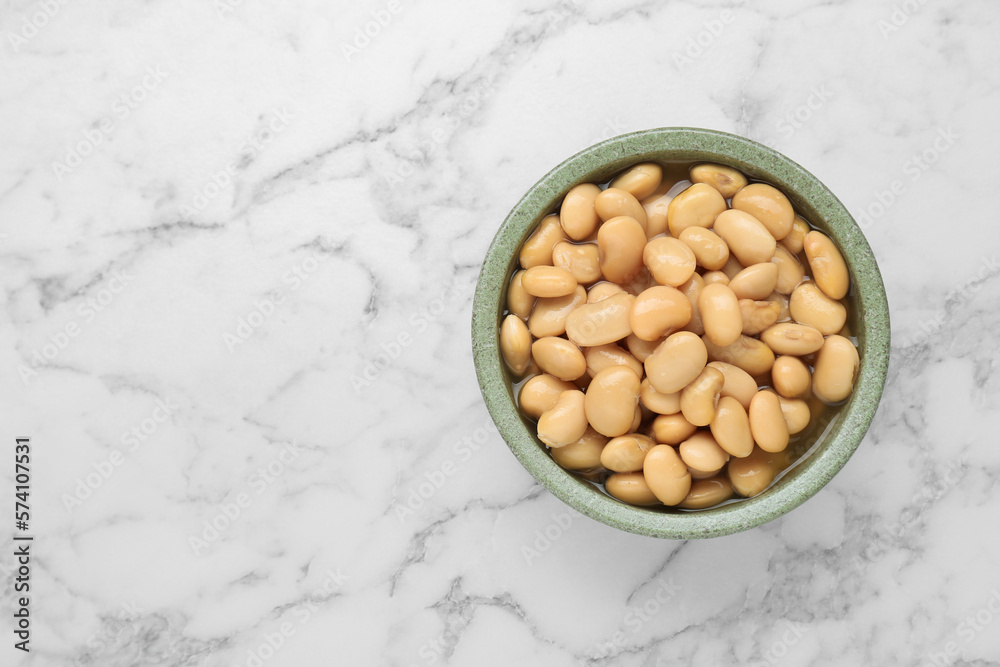 Bowl of canned kidney beans on white marble table, top view. Space for text Bowl of canned kidney beans on white marble table, top view. Space for text