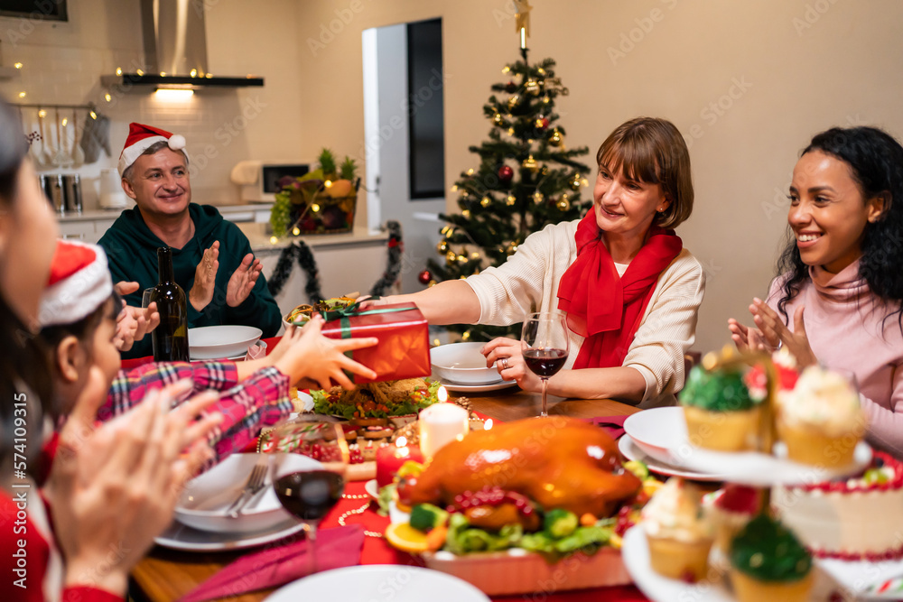 Multi-ethnic big family celebrating Christmas party together in house. Multi-ethnic big family celebrating Christmas party together in house.