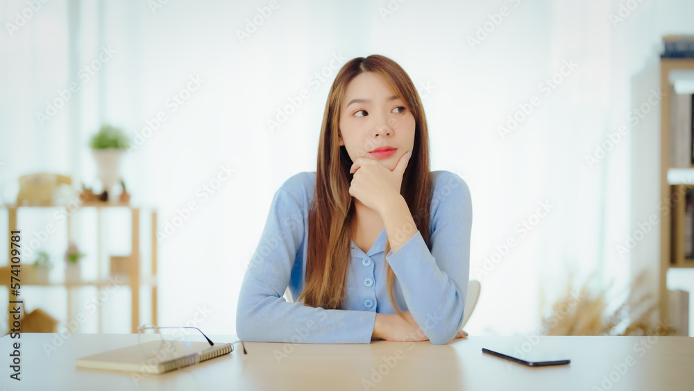Distracted from work worried young asian woman thinking of problems. Pensive unmotivated lady looking at window, feeling lack of energy Distracted from work worried young asian woman thinking of problems. Pensive unmotivated lady looking at window, feeling lack of energy