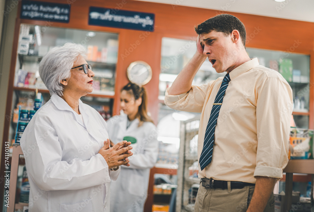 pharmacist is asking about a patient's condition in order to prescribe medication according to the patient's symptoms who come for prescription consultation in a modern pharmacy. pharmacist is asking about a patient's condition in order to prescribe medication according to the patient's symptoms who come for prescription consultation in a modern pharmacy.
