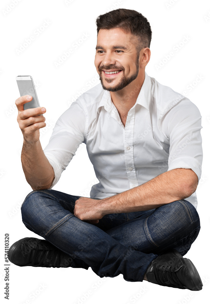 Young man writing message at his mobile phone Young man writing message at his mobile phone