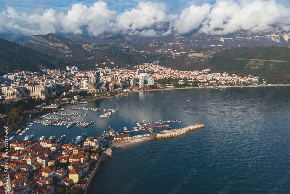 View of Budva old town, Budva Municipality and Riviera, resort on the Adriatic sea coast, Montenegro, sunny day with a blue sky, aerial drone view with beach and mountains, travel to Montenegro